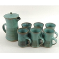 A studio pottery coffee set, comprising a lidded coffee pot, 14 by 19cm, with six mugs, 9.5 by 11.5c... 
