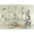 A group of ceramic figurines, comprising a Lladro figurine modelled as a seated ballet dancer, 12 by... 