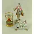 A Continental painted porcelain figure of a French nobleman with pink frock coat, 19th century, flor... 
