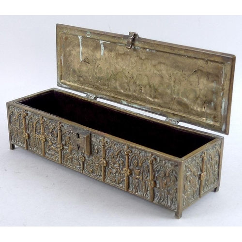 765 - A 19th century Gothic style brass casket, the sides and hinged lid all cast figures within lancet ar... 