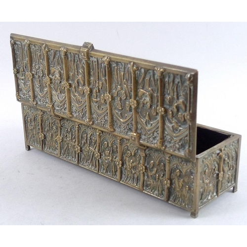 765 - A 19th century Gothic style brass casket, the sides and hinged lid all cast figures within lancet ar... 