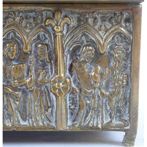 765 - A 19th century Gothic style brass casket, the sides and hinged lid all cast figures within lancet ar... 