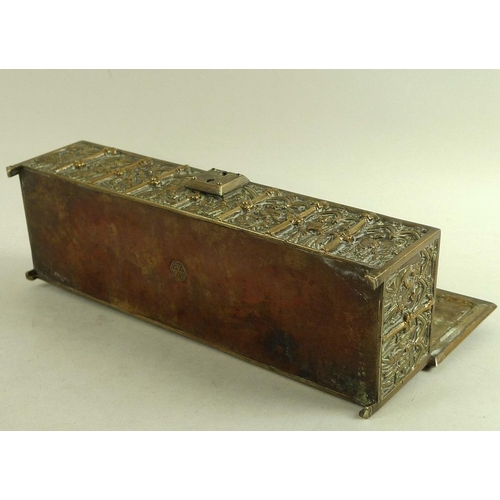 765 - A 19th century Gothic style brass casket, the sides and hinged lid all cast figures within lancet ar... 