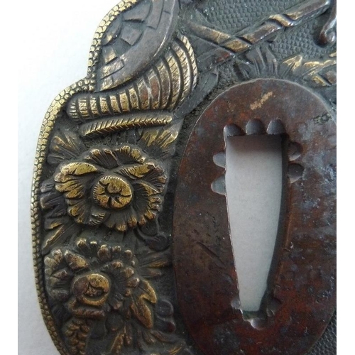 768 - A group of three Japanese tsuba, 19th and early 20th century, the first of mokkogata shape, cast in ... 