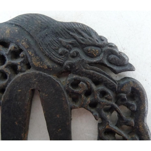 768 - A group of three Japanese tsuba, 19th and early 20th century, the first of mokkogata shape, cast in ... 