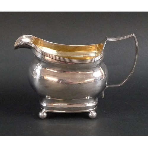 775 - A George III silver cream jug, ribbed rims to boat shaped body, oval cartouche to one side engraved ... 