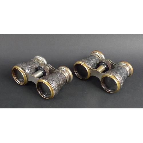 780 - A pair of Victorian silver and brass opera glasses, the silver bodies chased and embossed with scrol... 