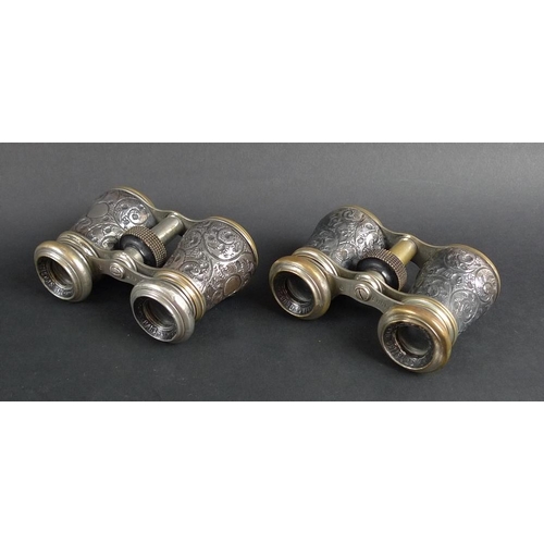 780 - A pair of Victorian silver and brass opera glasses, the silver bodies chased and embossed with scrol... 