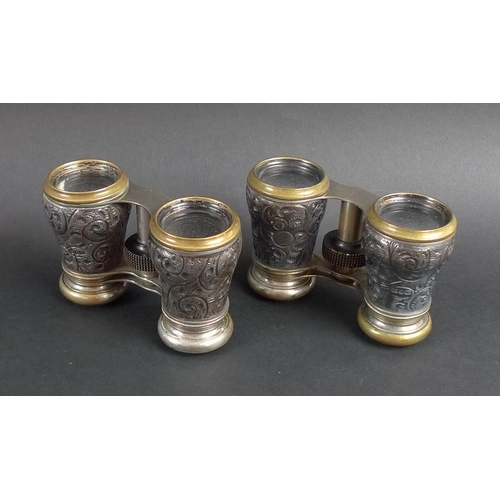 780 - A pair of Victorian silver and brass opera glasses, the silver bodies chased and embossed with scrol... 