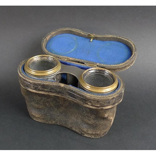 780 - A pair of Victorian silver and brass opera glasses, the silver bodies chased and embossed with scrol... 