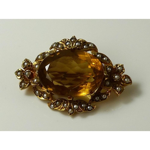 786 - A Victorian 9ct gold brooch set with large oval cut citrine and surrounded by seed pearls, marked to... 