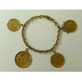 A 14ct gold cable chain bracelet with mounted full sovereign dated 1912, a 2000 Reis, face of Luis I... 