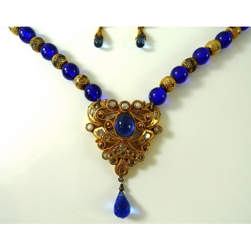 808 - An Indian kundan crystal and gold plated necklace, formed of alternating blue glass and textured gol... 