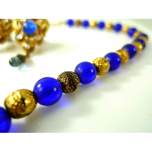 808 - An Indian kundan crystal and gold plated necklace, formed of alternating blue glass and textured gol... 