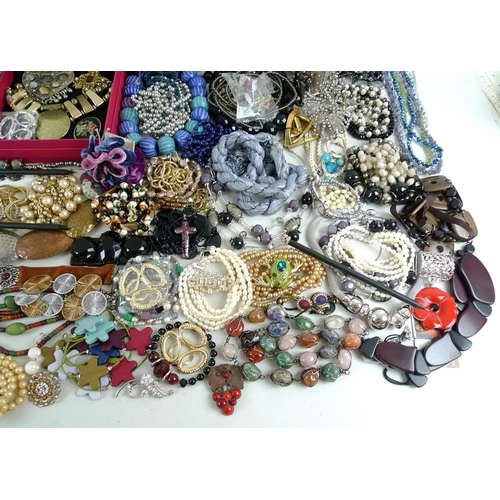 810 - A large quantity of costume jewellery, including glass beads, a Murano style glass cross pendant, se... 