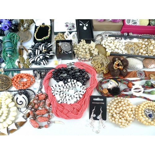 810 - A large quantity of costume jewellery, including glass beads, a Murano style glass cross pendant, se... 