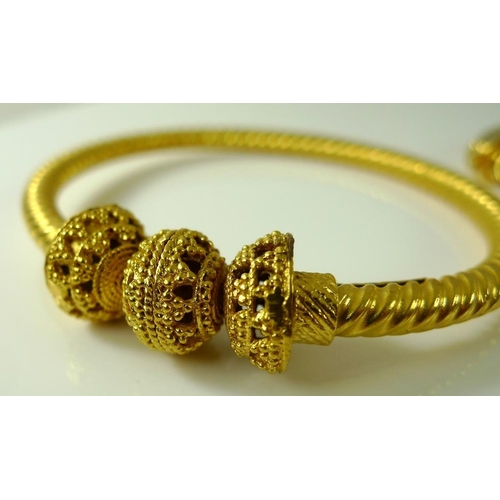 811 - Two Bengal bangles, gold plated, one of a rope twist design, 52.8g. (2)