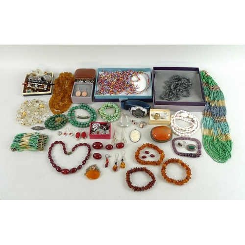 823 - A group of silver and vintage and later costume jewellery, including amber necklaces, bracelets and ... 