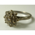 An 18ct white gold and diamond cluster ring, the central stone of approximately 0.05ct, approximatel... 