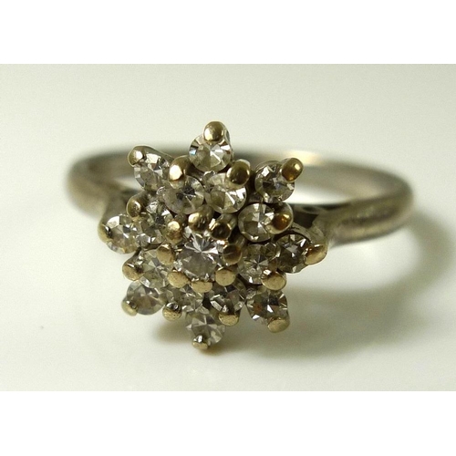 827 - An 18ct white gold and diamond cluster ring, the central stone of approximately 0.05ct, approximatel... 