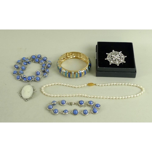 831 - A large quantity of vintage and later costume jewellery, including a locket, a jade cross, ceramic a... 