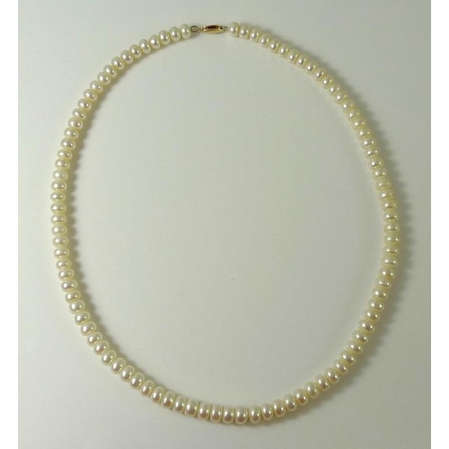 836 - A string of ivory coloured pearls with 14ct gold clasp, by Honora, in original box.