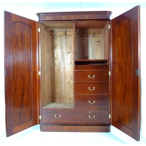 926A - A Victorian flame mahogany wardrobe, with two full hight doors enclosing a hanging space to the left... 