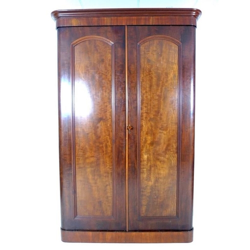 926A - A Victorian flame mahogany wardrobe, with two full hight doors enclosing a hanging space to the left... 