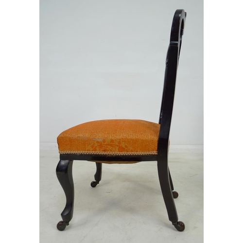 935 - A pair of Victorian mahogany salon chairs, the backs pierced and carved with scrolling foliate detai... 