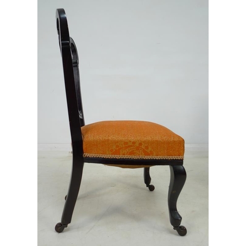 935 - A pair of Victorian mahogany salon chairs, the backs pierced and carved with scrolling foliate detai... 