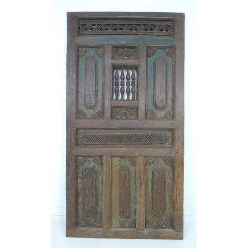 937 - A set of Moorish carved wooden doors, possibly 19th century, carved with motifs, 99 by 6 by 187.5cm ... 