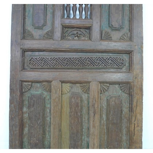 937 - A set of Moorish carved wooden doors, possibly 19th century, carved with motifs, 99 by 6 by 187.5cm ... 