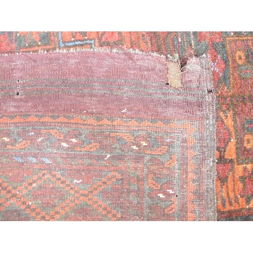 938 - A finely knotted Persian Hamadan/Tekke rug, early 20th century, with red/brown ground, twenty four g... 