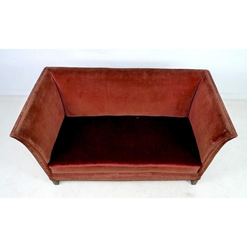 941 - An Edwardian two seater settee, with gently outswept sides, sprung seat and short square section leg... 