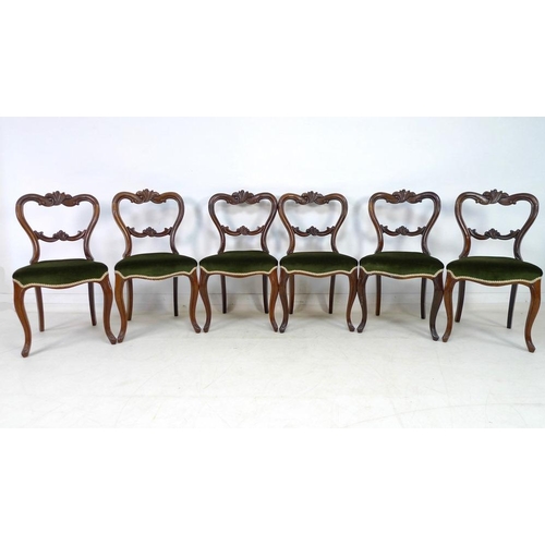 942 - A set of six Victorian rosewood dining chairs, with carved rails and moulded frames, upholstered in ... 