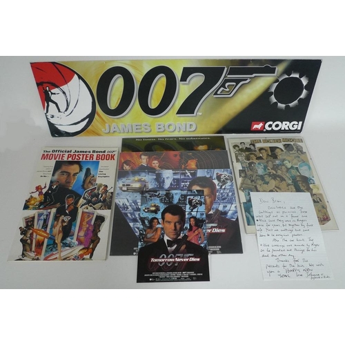 336 - A group of James Bond ephemera, comprising a pressed clipping collage, owned by Roger Moore and crea... 