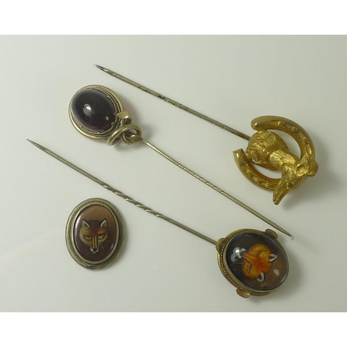 817 - An Intaglio stick pin with fox's mask, together with a stick pin set with a large oval cabochon garn... 