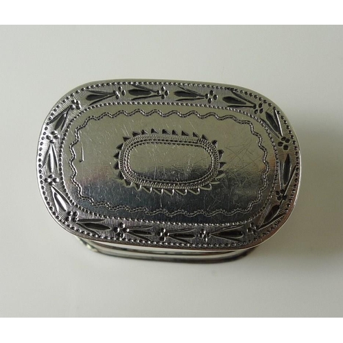 821 - A George III silver nutmeg grater, the oval body with engraved banding to upper lid which covers ste... 