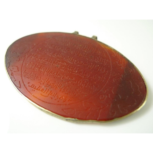 822 - A 19th century carved carnelian oval Arabic prayer pendant, inscribed with a prayer from the Quran, ... 