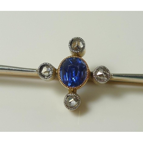 834 - A 15ct gold and platinum bar brooch, set with an oval sapphire surrounded by four small diamonds, ce... 