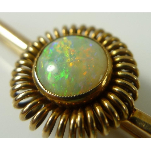 835 - A 14ct gold bar brooch set with an opal surrounded by gold spring halo, opal 0.9mm diameter, marked ... 