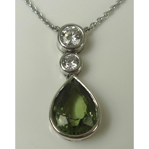 851 - A white 18ct gold, peridot and diamond pendant and chain, the pear cut peridot of approximately 9.8 ... 