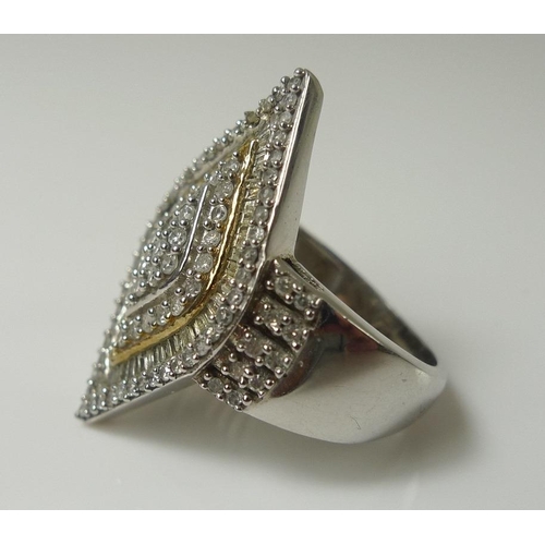 853 - A diamond dress ring, the marquise shaped design set with rows of pave set point and baguette diamon... 