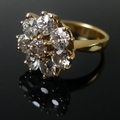 An 18ct gold and diamond dress ring, formed of eight old cut diamonds in a cluster design, claw set,... 