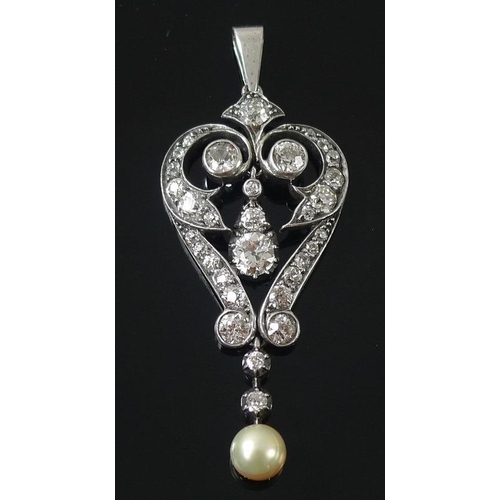 859 - An early Art Deco diamond and pearl pendant, circa 1915, the scrolled setting with suspended central... 