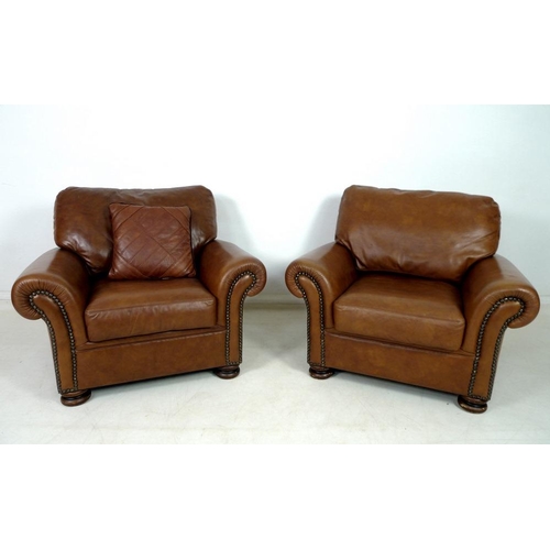 862 - A pair of modern John Lewis armchairs, each upholstered in brown leather, with roll over arms and bu... 