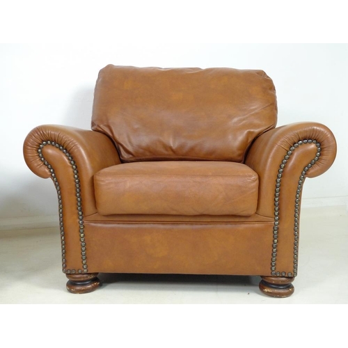 862 - A pair of modern John Lewis armchairs, each upholstered in brown leather, with roll over arms and bu... 