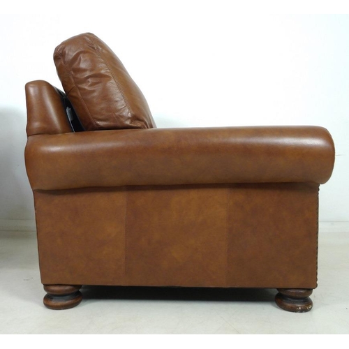 862 - A pair of modern John Lewis armchairs, each upholstered in brown leather, with roll over arms and bu... 