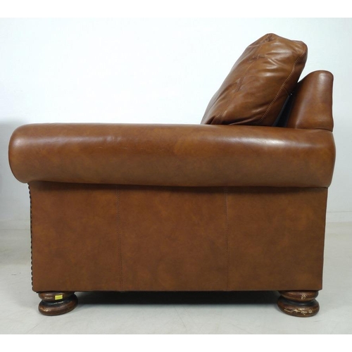 862 - A pair of modern John Lewis armchairs, each upholstered in brown leather, with roll over arms and bu... 