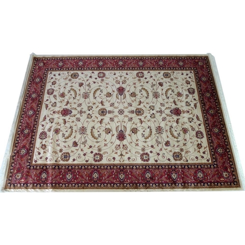 874 - A modern Keshan rug, beige ground with scrolling foliate decoration, wide dark red border, 280 by 20... 